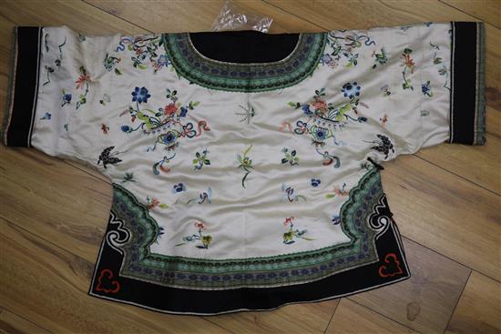 A Chinese embroidered silk ladys jacket and pair of shoes